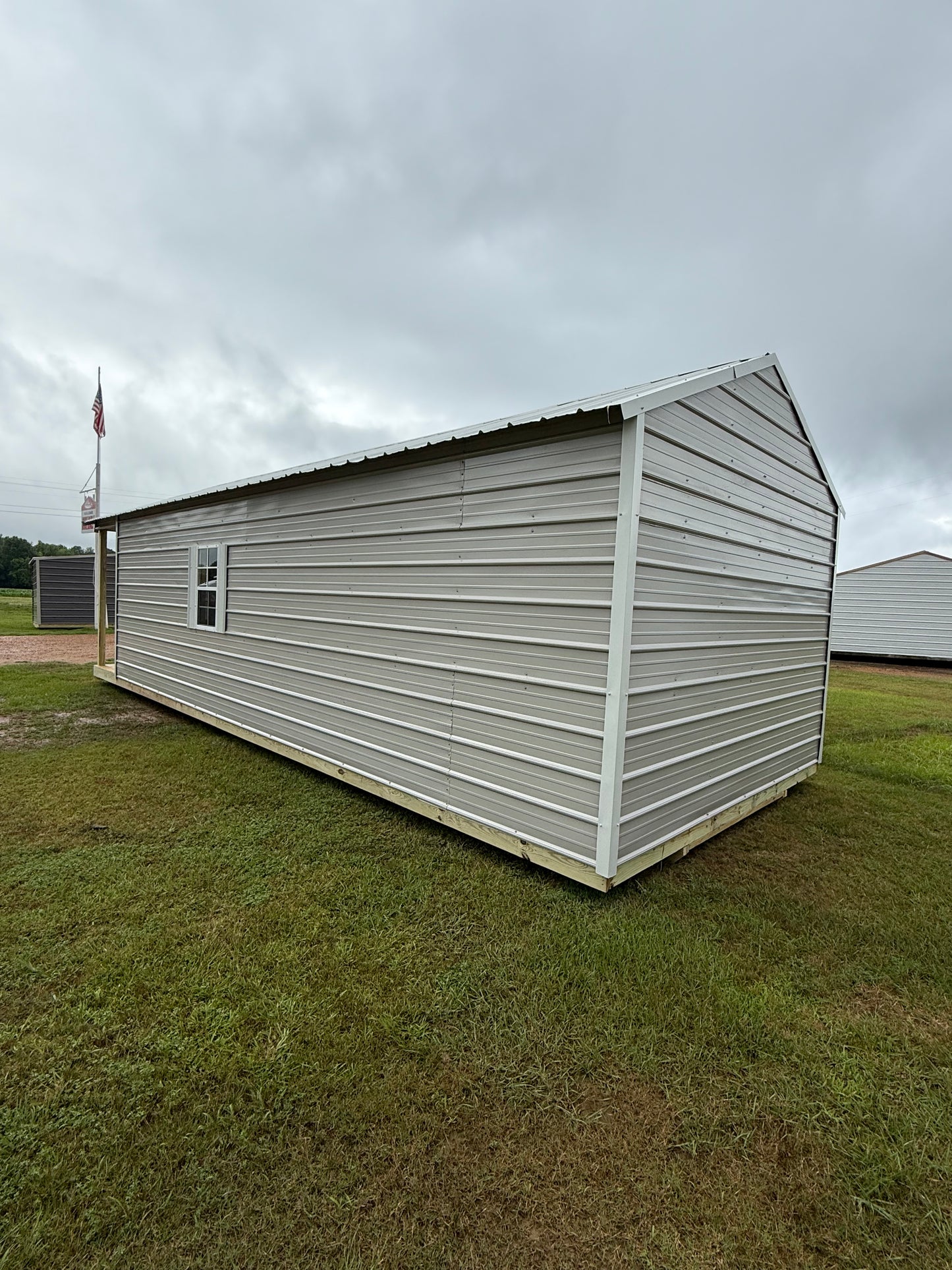 side and back of 12x32 peak cabin gray/alamo white