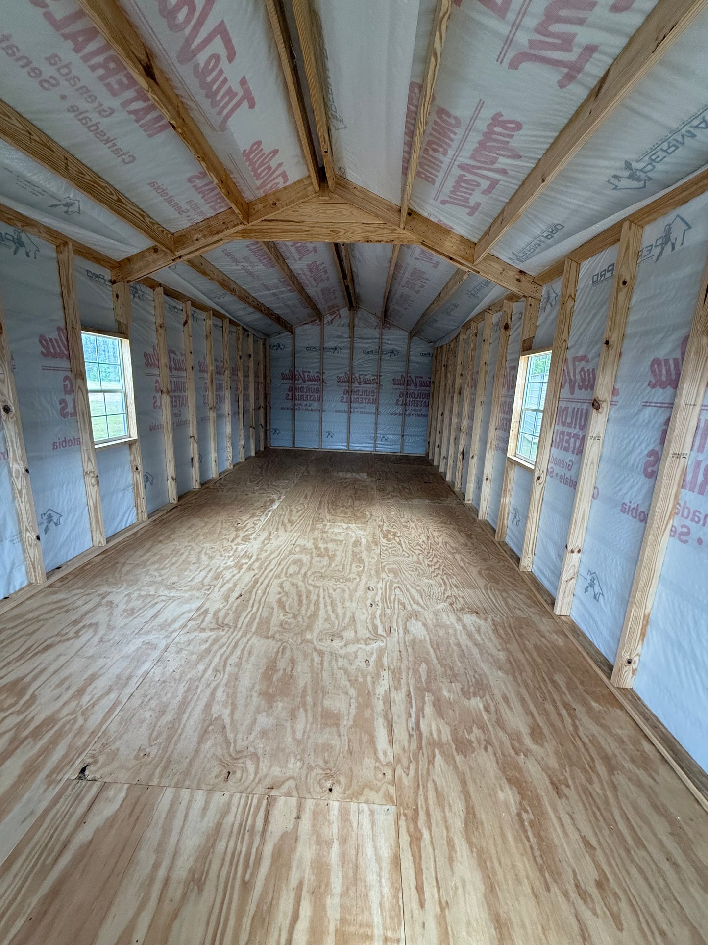 Inside 12x32 Peak Cabin with house wrap included