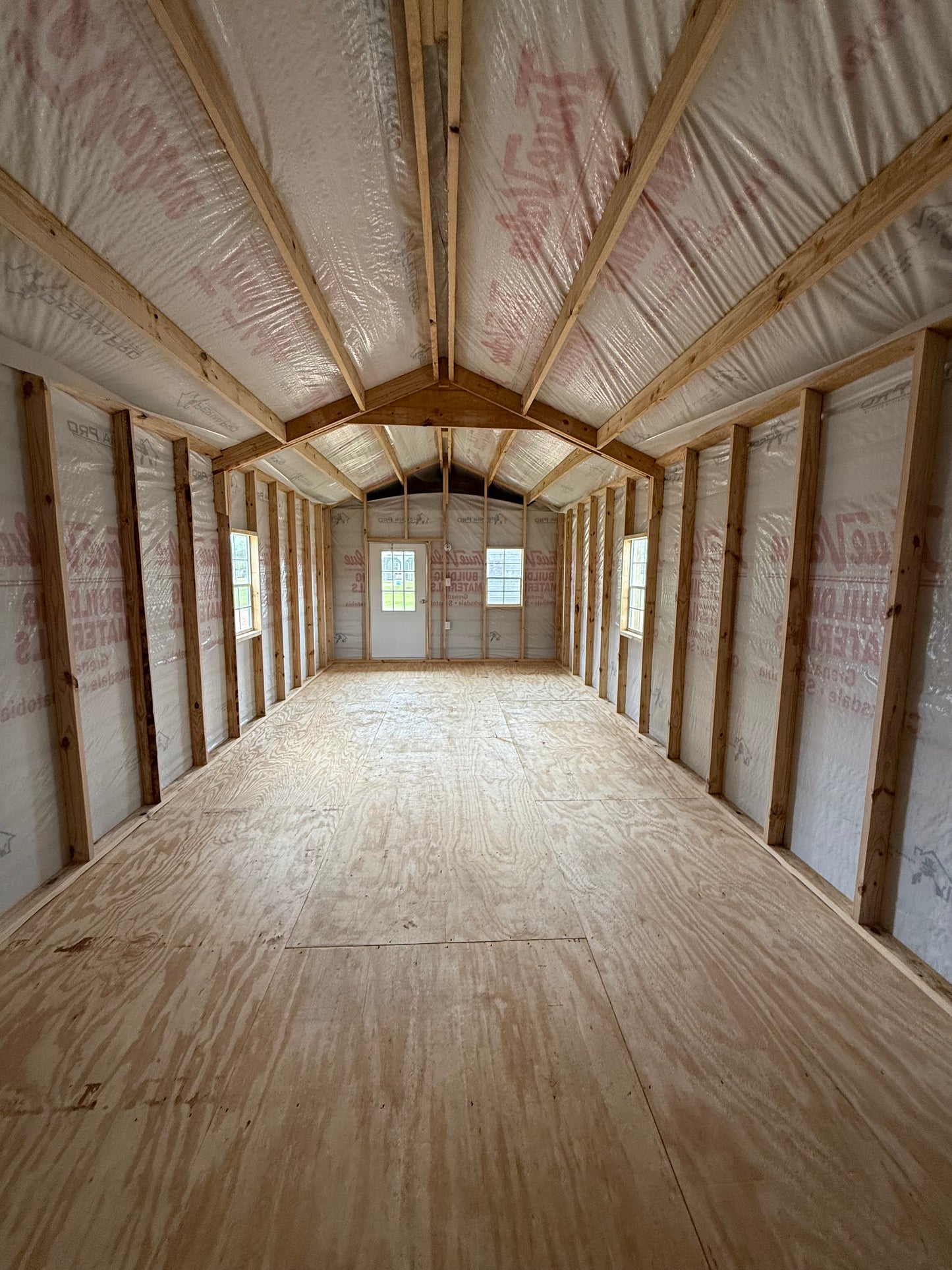inside 12x32 peak cabin with house wrap included