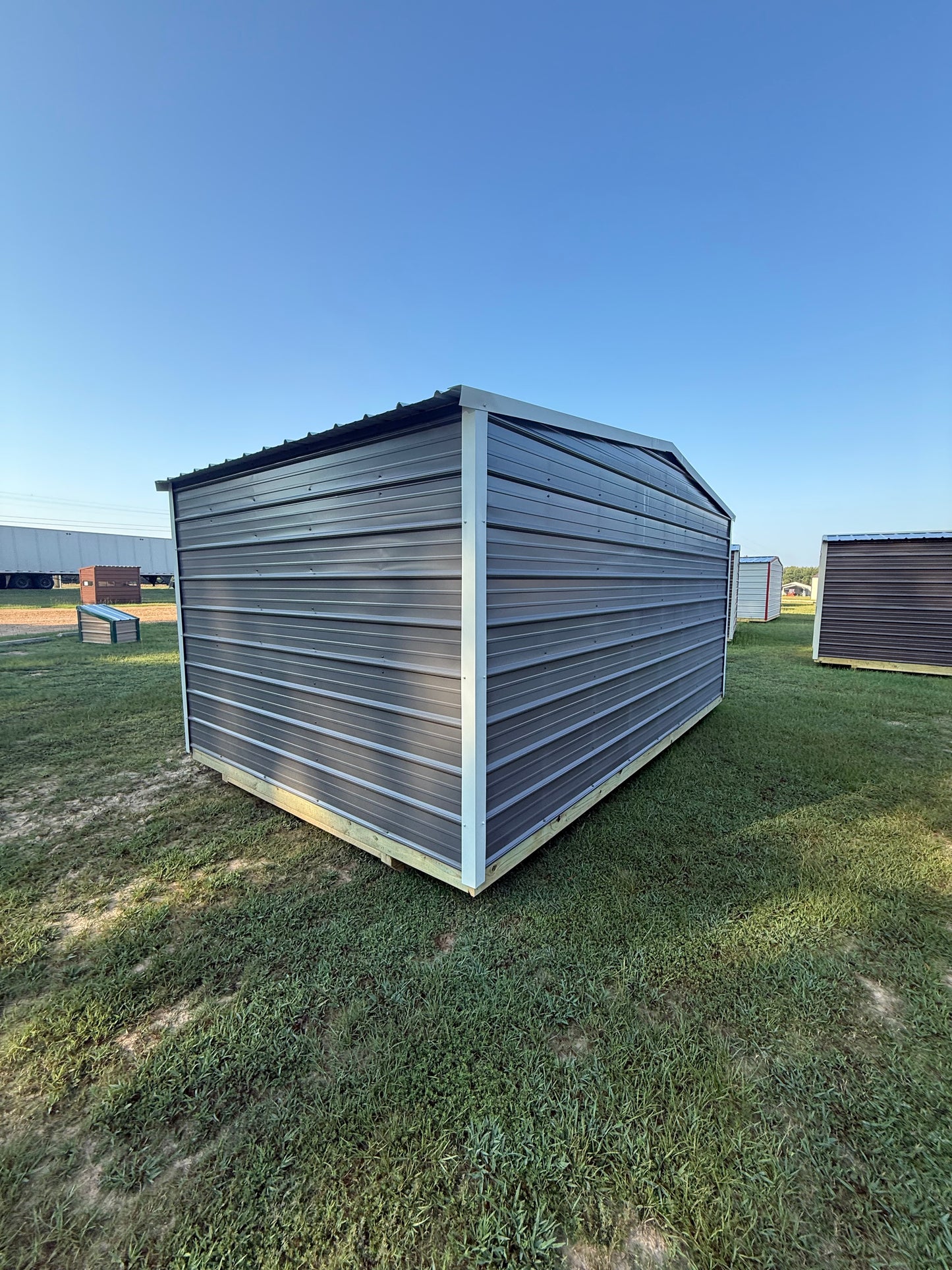 side/back of 10x16 charcoal/ alamo white regular roof portable building