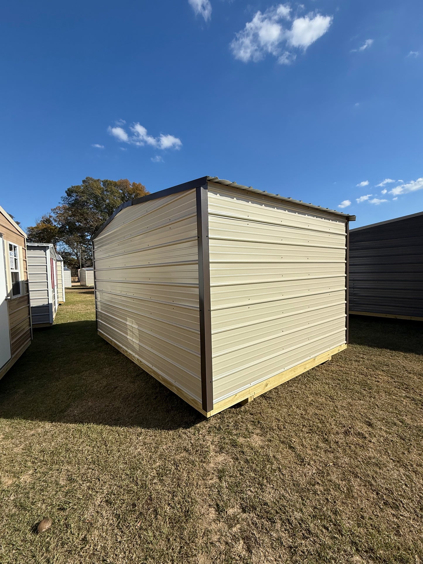 back/side view of a 10x14 light stone/burnished slate regular roof portable building