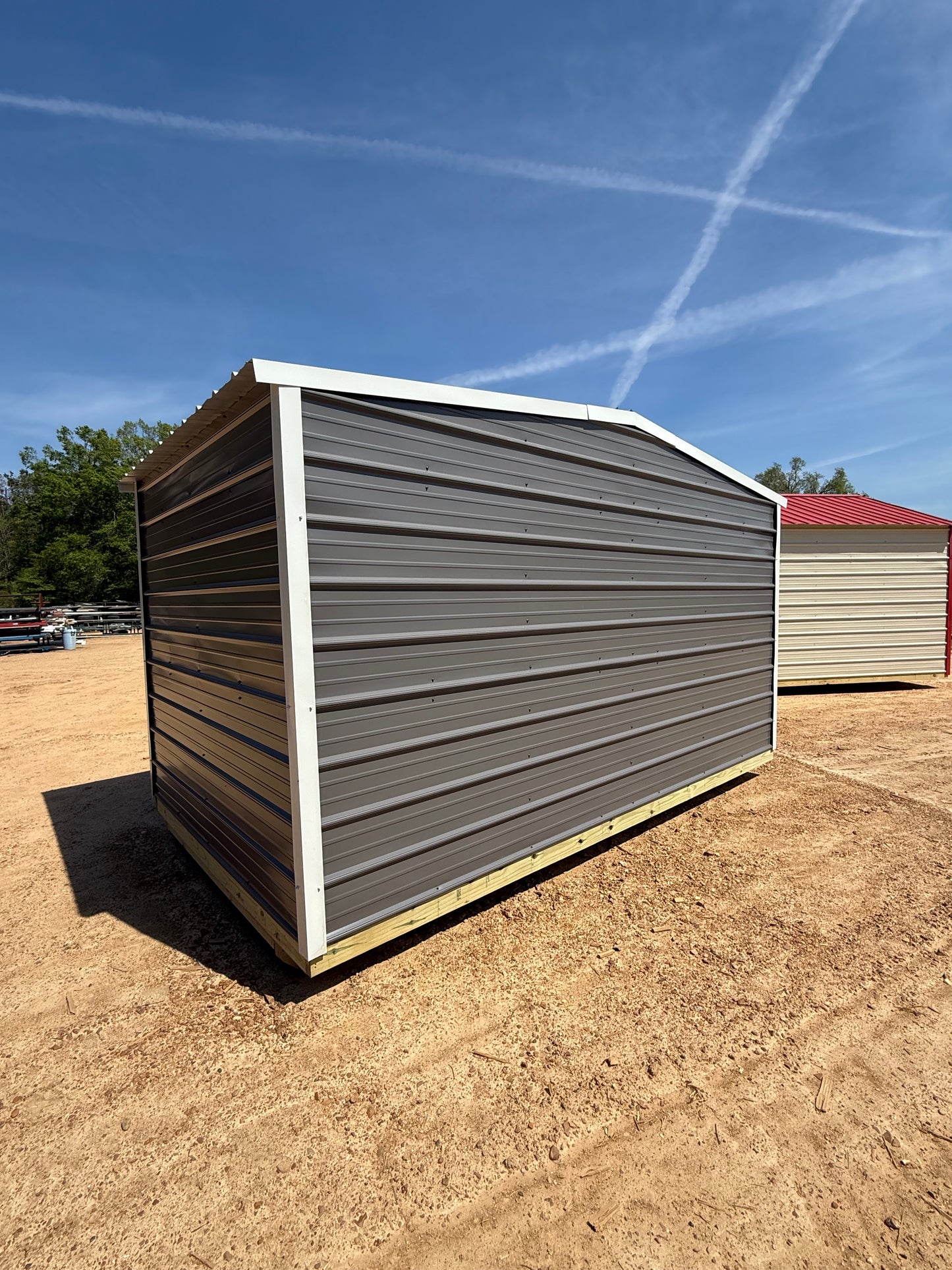 back view of 8x14 charcoal/alamo white regular roof portable building 
