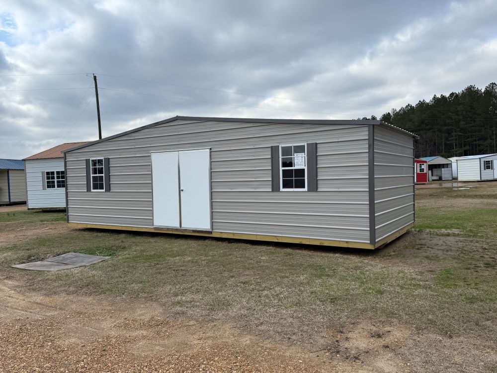 front of a 12x30 gray with charcoal trim building with a 6' double door 