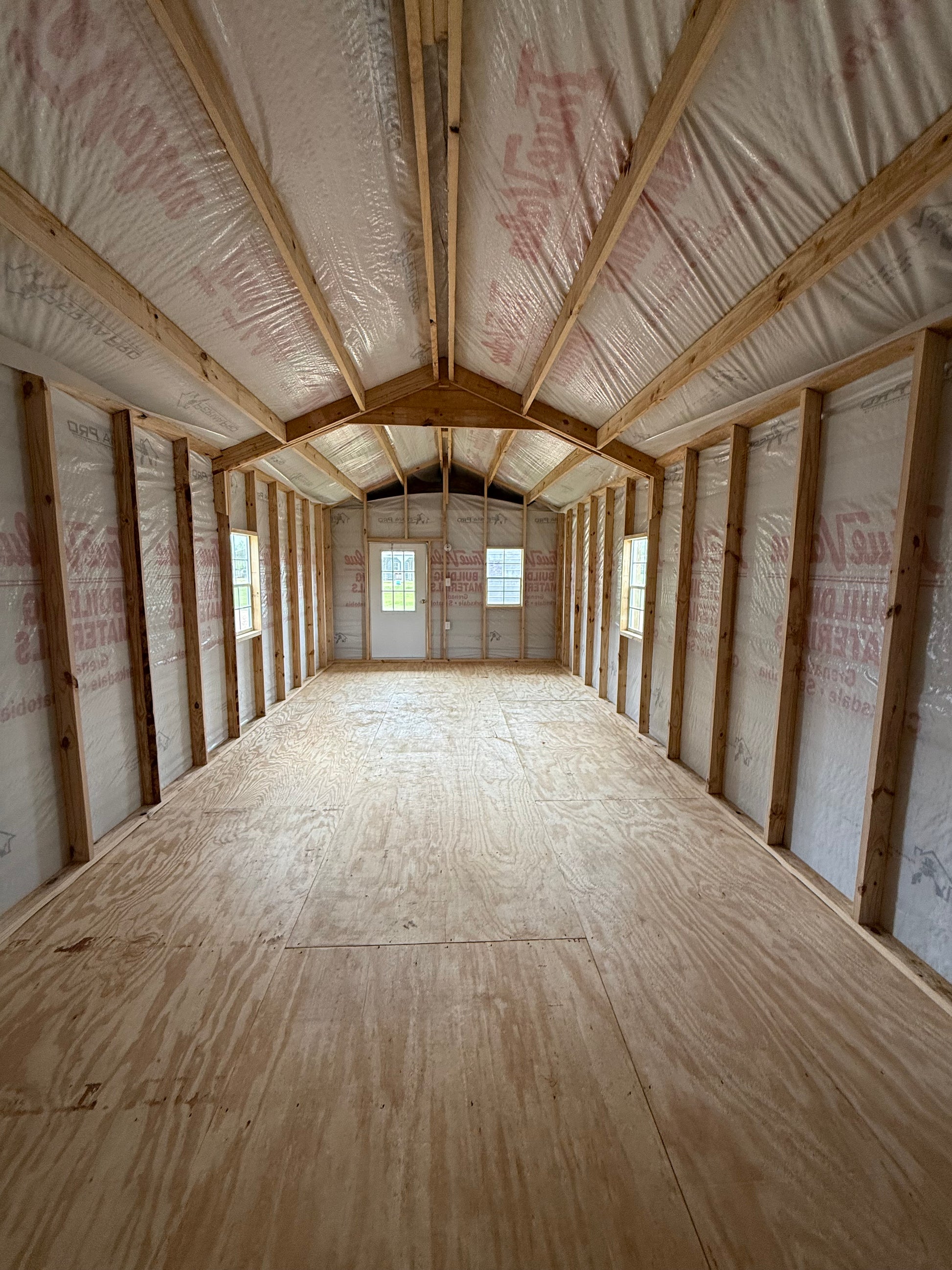 inside 12x32 peak cabin with house wrap included