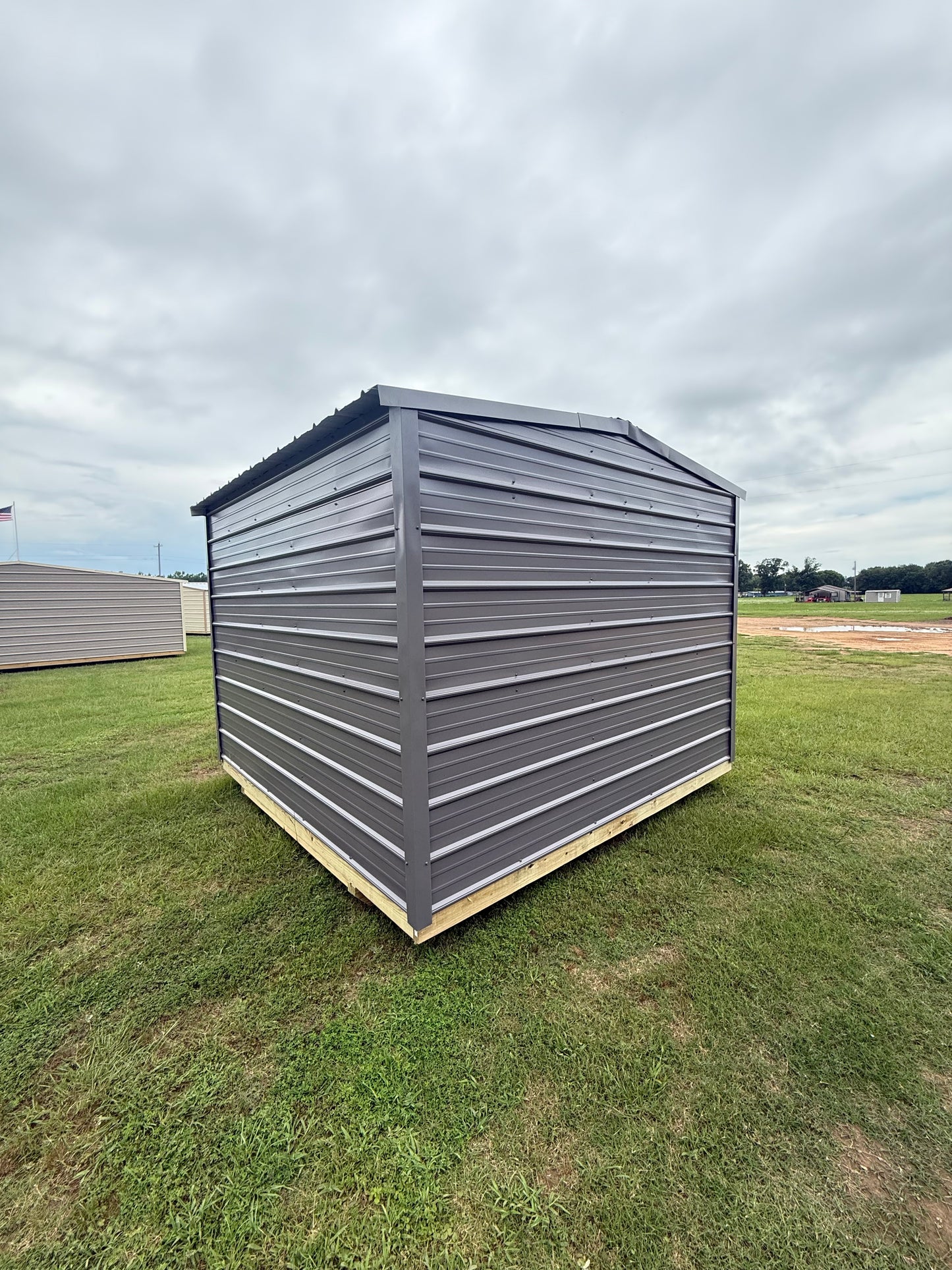 back/side view of charcoal/charcoal portable building 