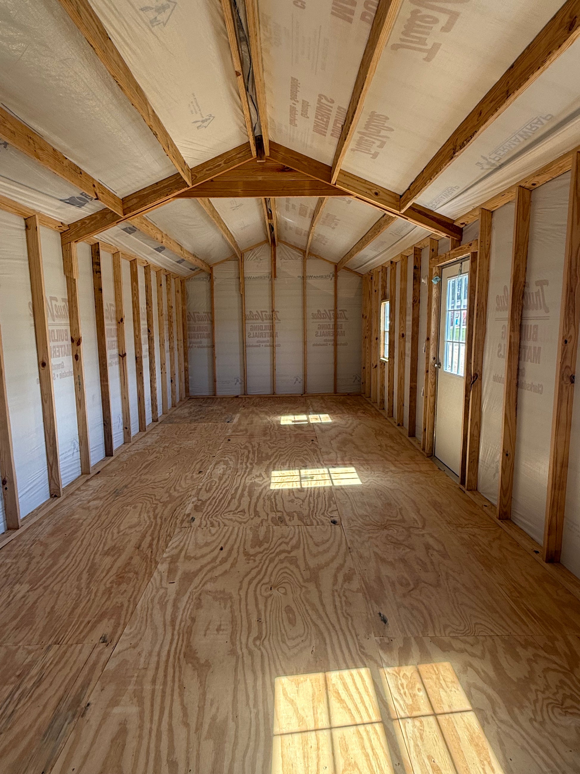 inside view of 12x32 peak roof building featuring house wrap