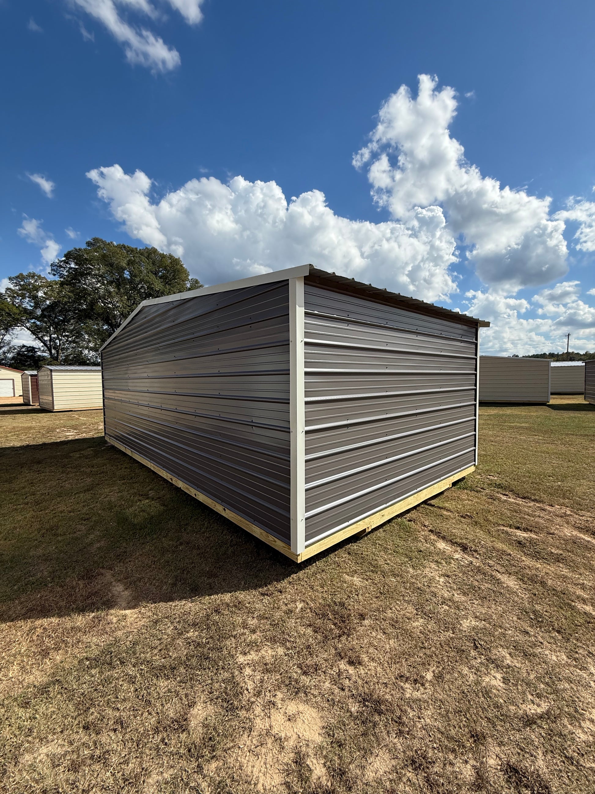 back/side view of 12x24 charcoal/alamo white regular roof portable building 