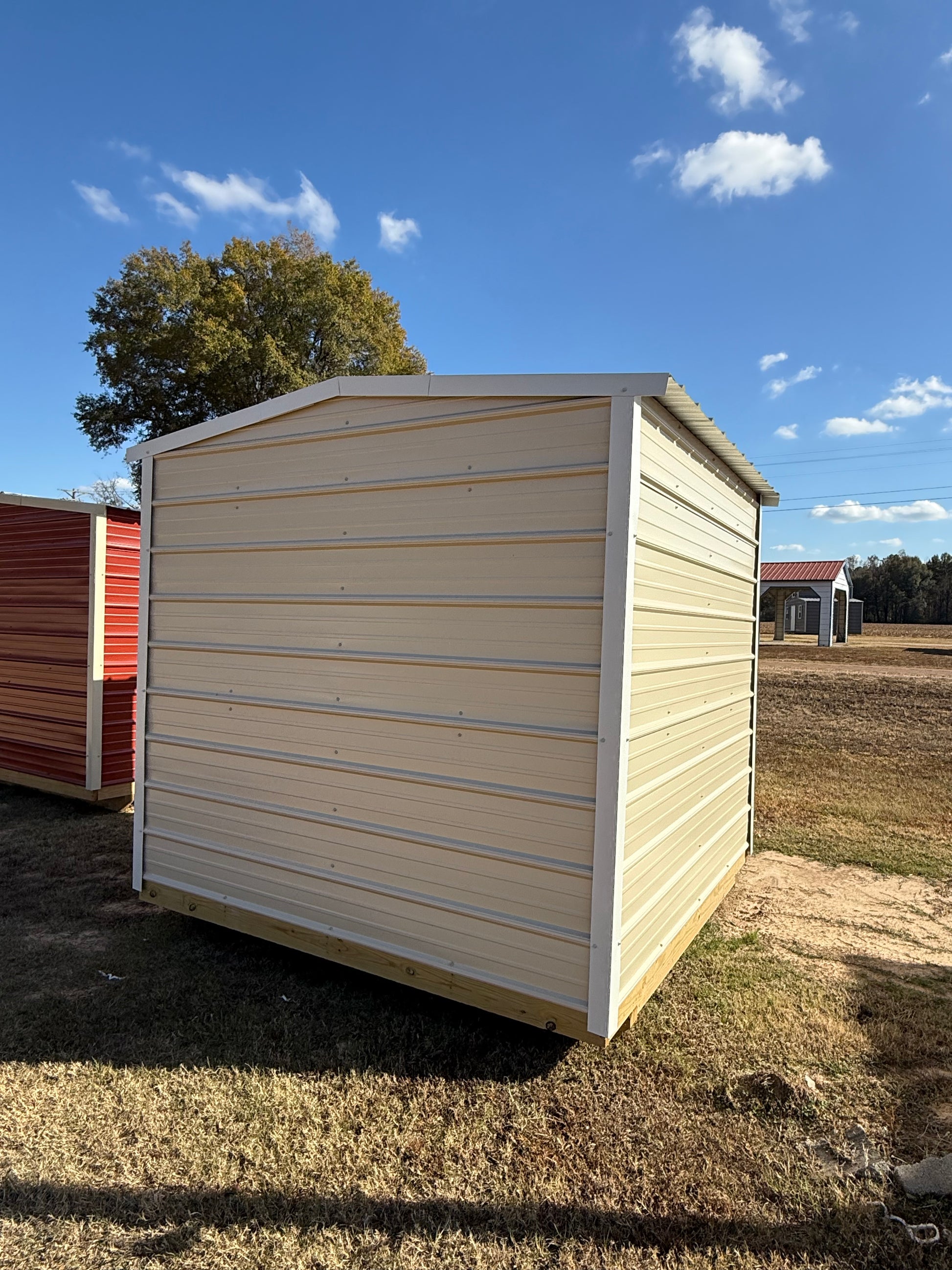 back/side view of regular roof portable storage building 