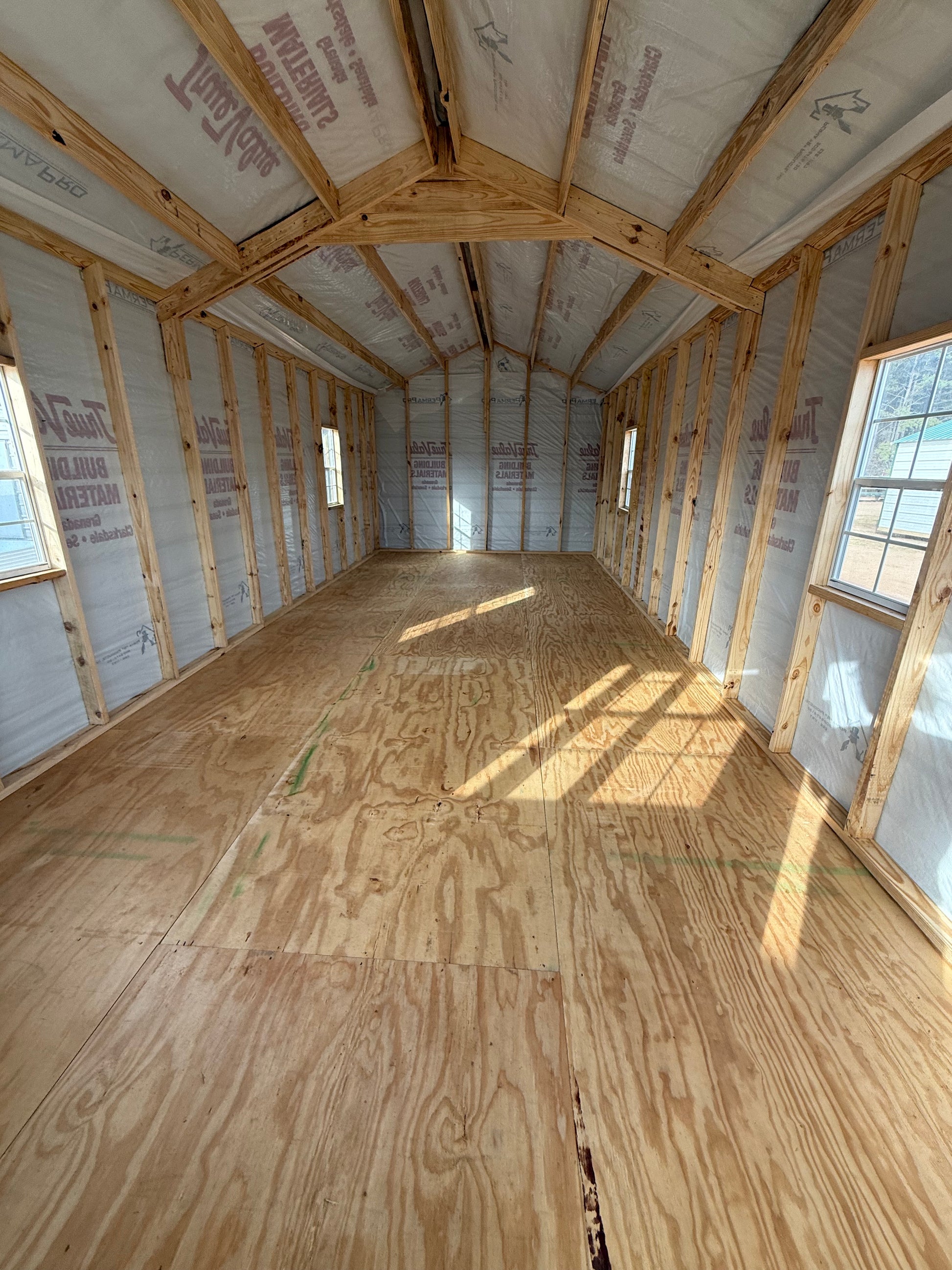 inside view of 12x32 peak cabin with house wrap