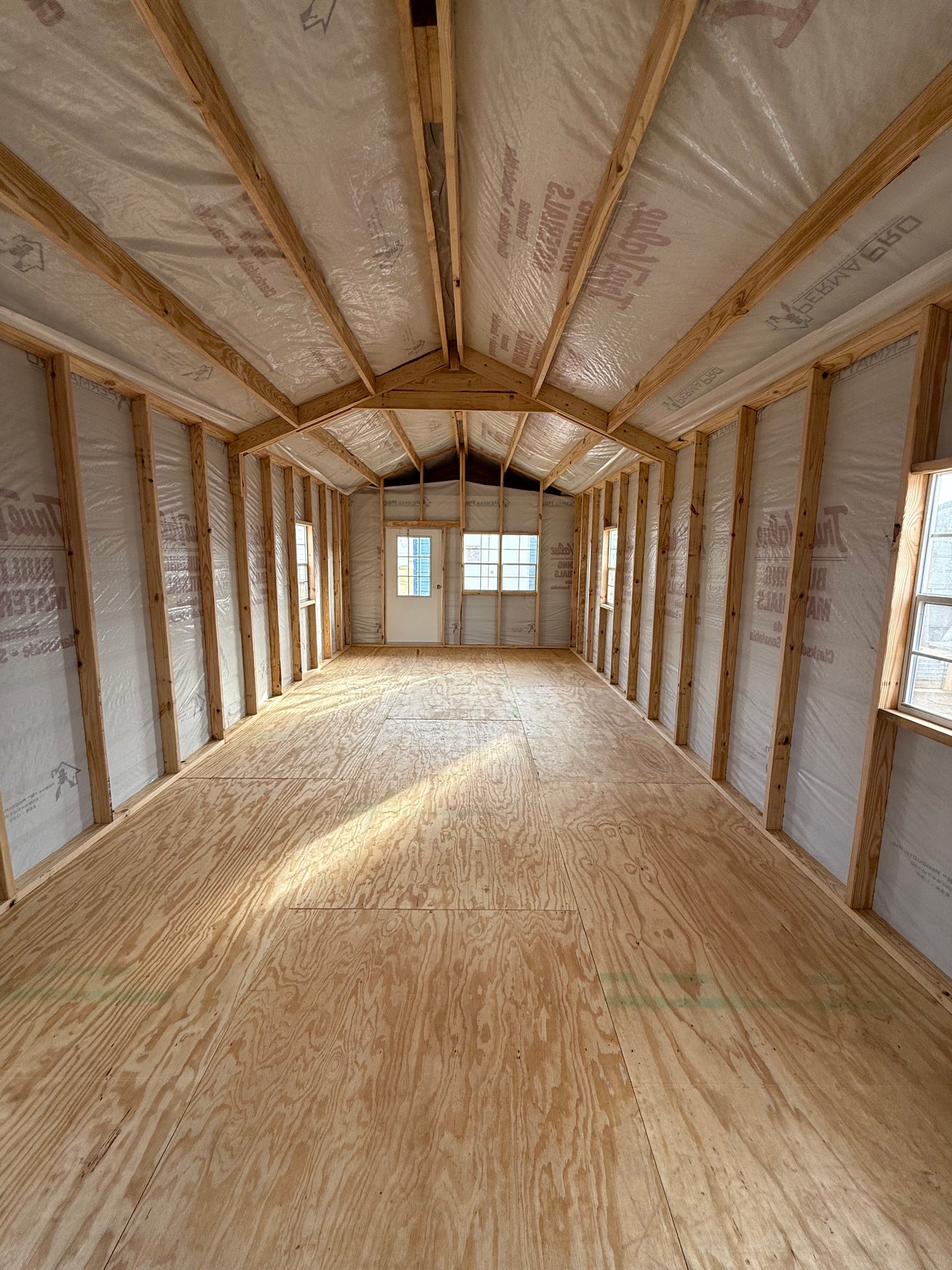 inside view of 12x32 peak cabin with house wrap 
